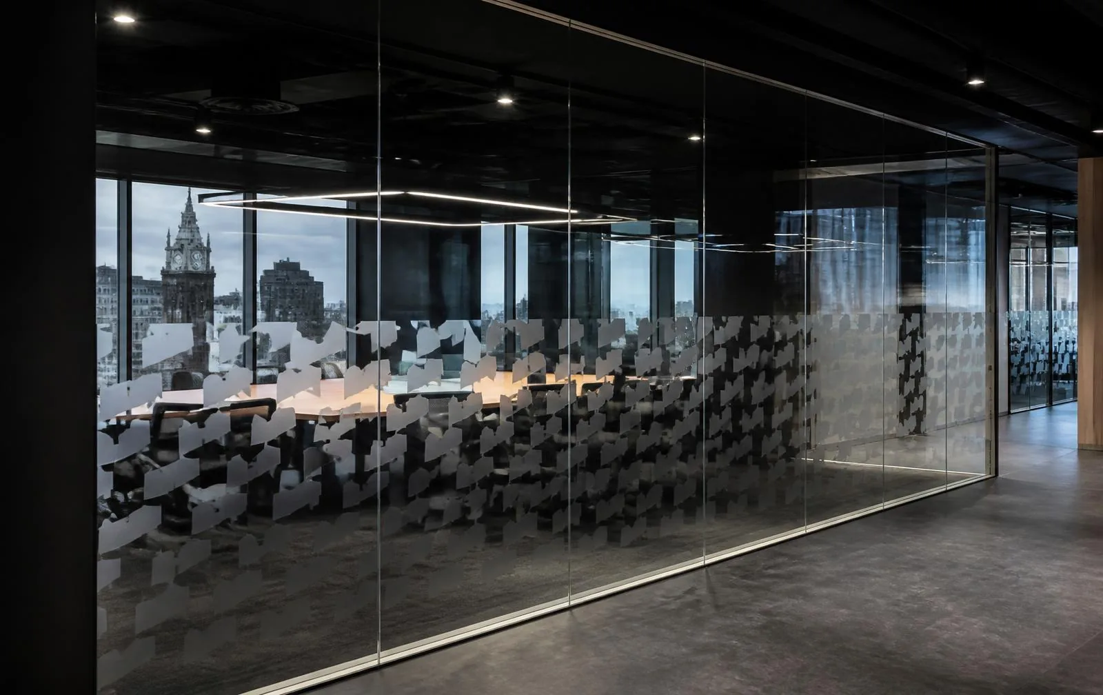 Frosted logo-repeat manifestation film applied to a glazed office partition